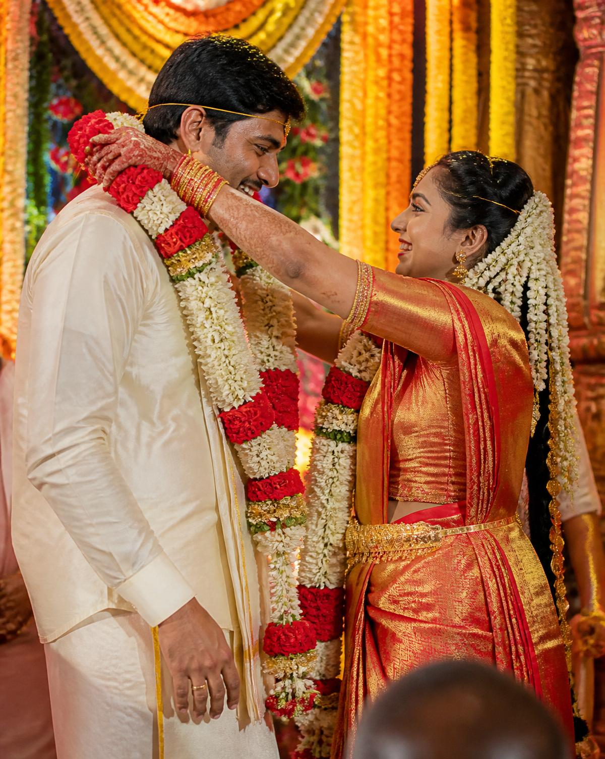 South Indian bride and groom exchanging garlands
